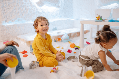 children playing in the snow in a playroom