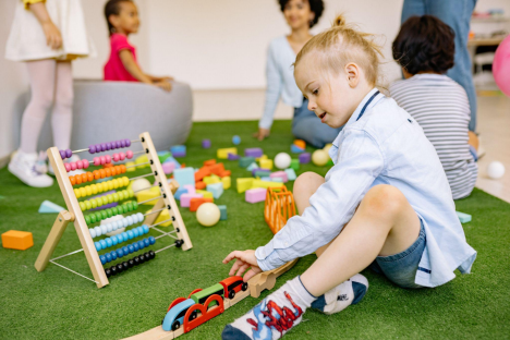 a young child playing with toys in a playroom